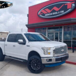 White 2015 Ford F150 with 4" Rough Country Lift on 22x12 Forgiato Flow Terra FT004 Wheels in Gloss Black Milled & 285/45R22 Nitto Recon Grappler Tires