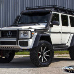 White Mercedes G550 4x4 Squared G-Wagon on 22x10 Forgiato Gambe-1 Wheels in Gloss Black with White Inserts & 37" Toyo Open Country R/T Tires White Mercedes G550 4x4 Squared G-Wagon on 22x10 Forgiato Gambe-1 Wheels in Gloss Black with White Inserts & 37" Toyo Open Country R/T Tires