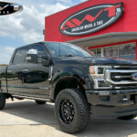 Black Ford F250 with ReadyLift Level Lift on 20x9 Fuel Off Road D795 Arc Wheels in Gloss Black Milled & 295/65R20 Nitto Ridge Grappler Tires Black Ford F250 with ReadyLift Level Lift on 20x9 Fuel Off Road D795 Arc Wheels in Gloss Black Milled & 295/65R20 Nitto Ridge Grappler Tires