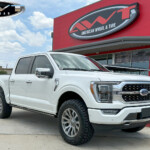 White 2023 Ford F150 with 2" ReadyLift Level Lift on 20x9 Fuel Off-Road D693 Blitz Wheels in Platinum & 35x11.50R20 Nitto Ridge Grappler Tires White 2023 Ford F150 with 2" ReadyLift Level Lift on 20x9 Fuel Off-Road D693 Blitz Wheels in Platinum & 35x11.50R20 Nitto Ridge Grappler Tires