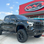 Black 2024 Chevrolet Silverado 1500 with 6" Rough Country Lift on 22x10 Fuel Off-Road Flame Wheels & 35" Venom Power Terra Hunter X/T Tires Black 2024 Chevrolet Silverado 1500 with 6" Rough Country Lift on 22x10 Fuel Off-Road Flame Wheels & 35" Venom Power Terra Hunter X/T Tires