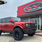 Red 2023 Ford Bronco with 2" Rough Country Lift on 20x10 Fuel Off-Road Quake Wheels & 35" Toyo Open Country A/T Tires Red 2023 Ford Bronco with 2" Rough Country Lift on 20x10 Fuel Off-Road Quake Wheels & 35" Toyo Open Country A/T Tires