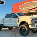 White 2023 Ford F250 with 5" BDS Lift on 24x12 Fuel Off-Road Forged FF75 Wheels & 37" Nitto Ridge Grappler Tires White 2023 Ford F250 with 5" BDS Lift on 24x12 Fuel Off-Road Forged FF75 Wheels & 37" Nitto Ridge Grappler Tires