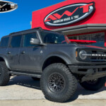 Gray 2023 Ford Bronco with 3.5" Rough Country Lift on 17" KMC KM722 Technic Wheels & 37x12.50R17 Nitto Ridge Grappler Tires Gray 2023 Ford Bronco with 3.5" Rough Country Lift on 17" KMC KM722 Technic Wheels & 37x12.50R17 Nitto Ridge Grappler Tires