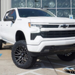 White 2024 Chevrolet Silverado 1500 with 6" Rough Country Lift on 20" TIS Offroad 554BM Wheels & 35" Nitto Recon Grappler Tires White 2024 Chevrolet Silverado 1500 with 6" Rough Country Lift on 20" TIS Offroad 554BM Wheels & 35" Nitto Recon Grappler Tires