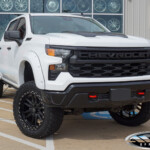 White 2024 Chevrolet Silverado 1500 Trail Boss with 6" Rough Country Lift on 22" Lexani XVR-1 Off-Road Veneta Wheels & 35" Venom Power Terra Hunter X/T Tires White 2024 Chevrolet Silverado 1500 Trail Boss with 6" Rough Country Lift on 22" Lexani XVR-1 Off-Road Veneta Wheels & 35" Venom Power Terra Hunter X/T Tires