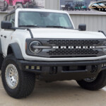 White 2024 Ford Bronco Badlands on 17x9 Black Rhino Primm Wheels in Silver Machined White 2024 Ford Bronco Badlands on 17x9 Black Rhino Primm Wheels in Silver Machined