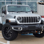 Silver 2024 Jeep Wrangler Sahara Unlimited JL on 20x10 Fuel Off-Road Krank Wheels in Black & 33x12.50R20 Venom Power Terra Hunter R/T Tires Silver 2024 Jeep Wrangler Sahara Unlimited JL on 20x10 Fuel Off-Road Krank Wheels in Black & 33x12.50R20 Venom Power Terra Hunter R/T Tires